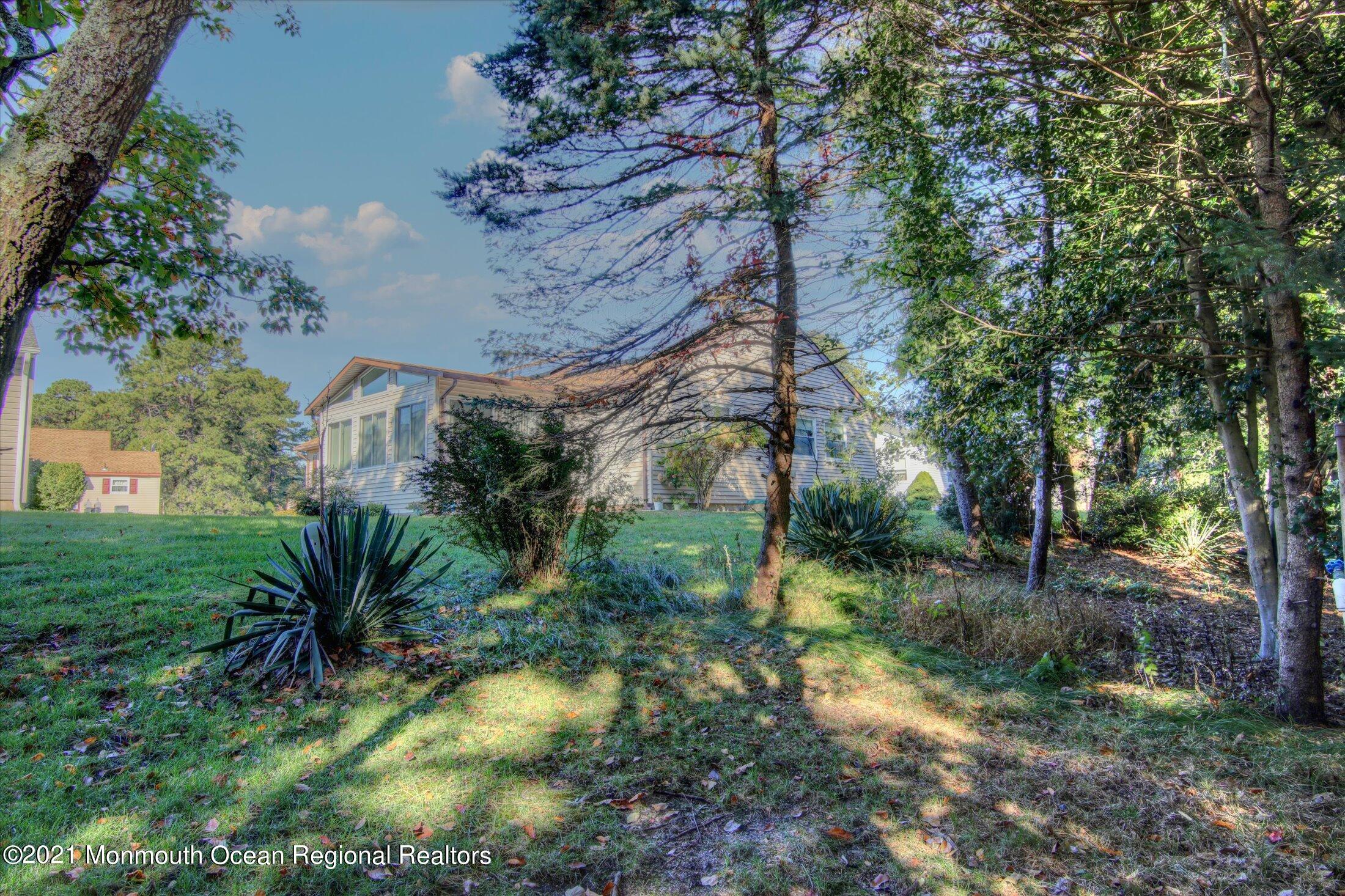 17 Ashley Road Whiting, NJ 08759 - Photo 26 of 31 a view of a yard with plants and large trees