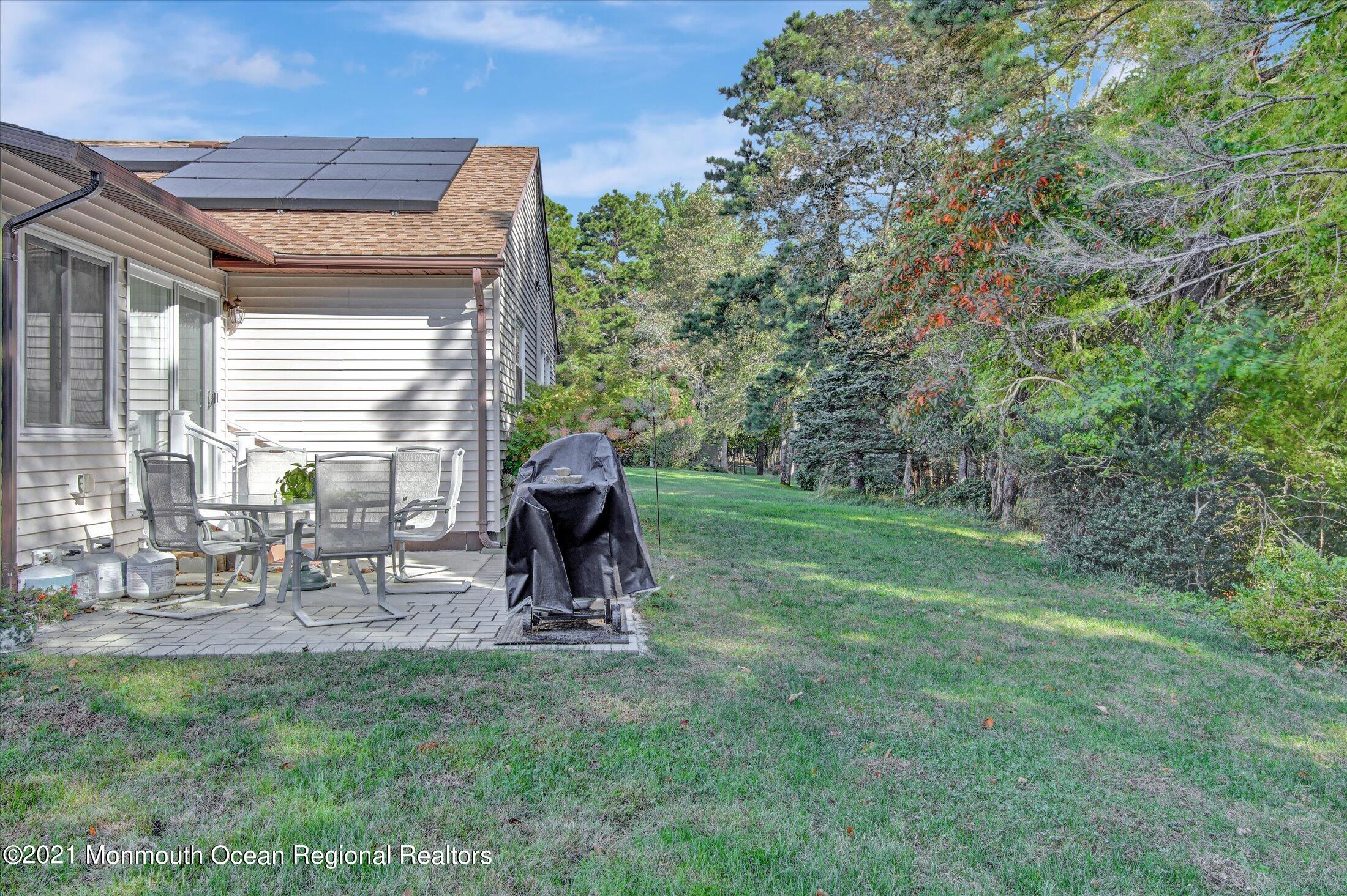 17 Ashley Road Whiting, NJ 08759 - Photo 27 of 31 a view of backyard with a table and chairs