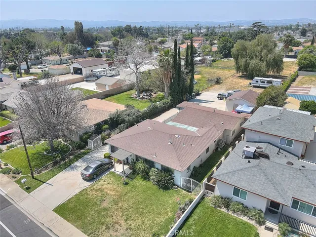 an aerial view of a house with a garden and lake view