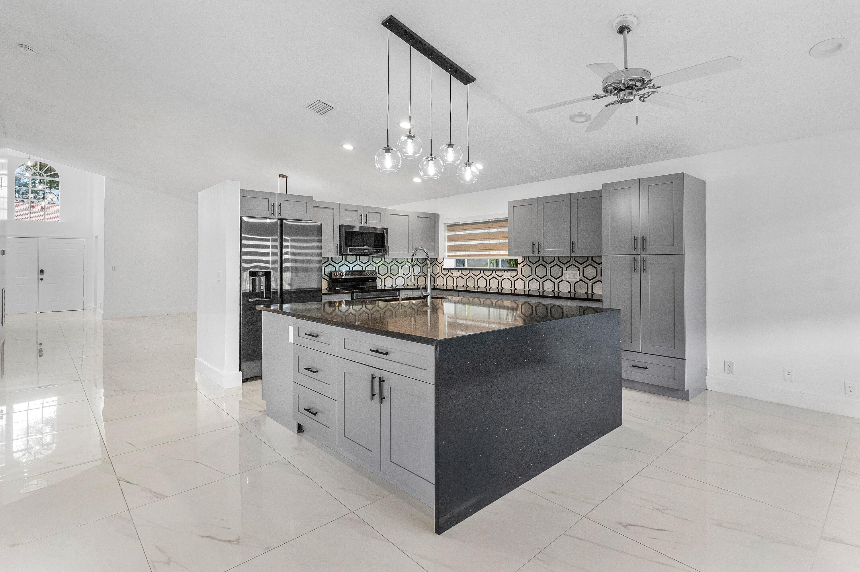 11163 180th Court South Boca Raton, FL 33498 - Photo 1 of 22 a kitchen with stainless steel appliances granite countertop a refrigerator and a sink