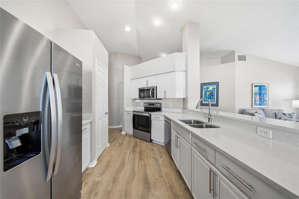 2119 Cattleman Drive Brandon, FL 33511 - Photo 13 of 46 a kitchen with stainless steel appliances granite countertop a refrigerator and a sink