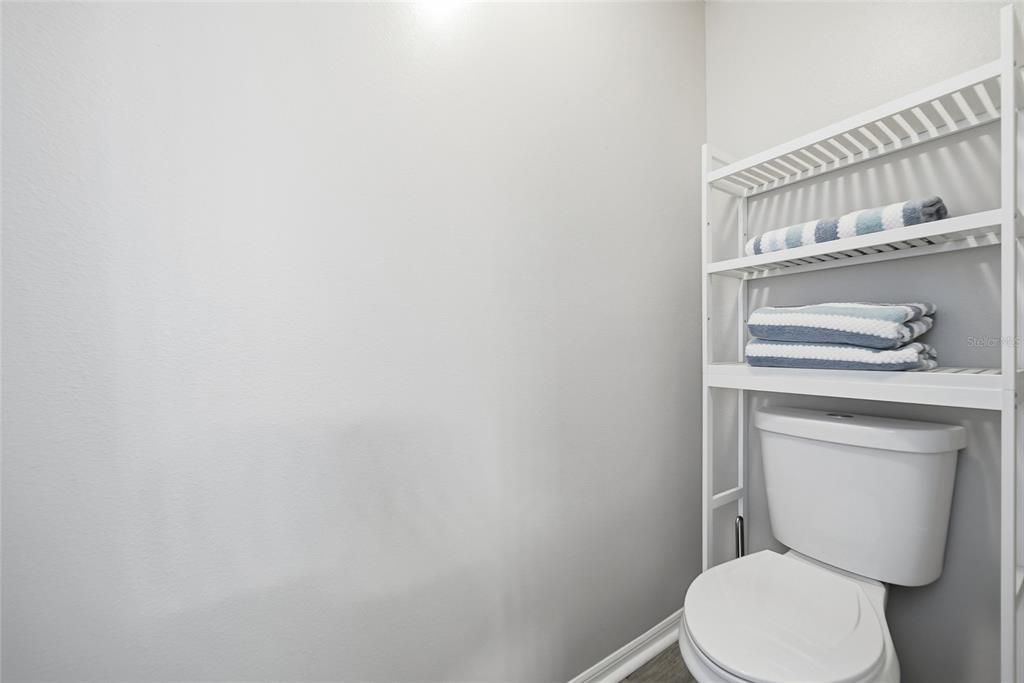 2119 Cattleman Drive Brandon, FL 33511 - Photo 30 of 46 a white toilet sitting next to a shower curtain