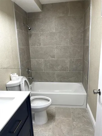 a bathroom with a toilet a sink and bathtub