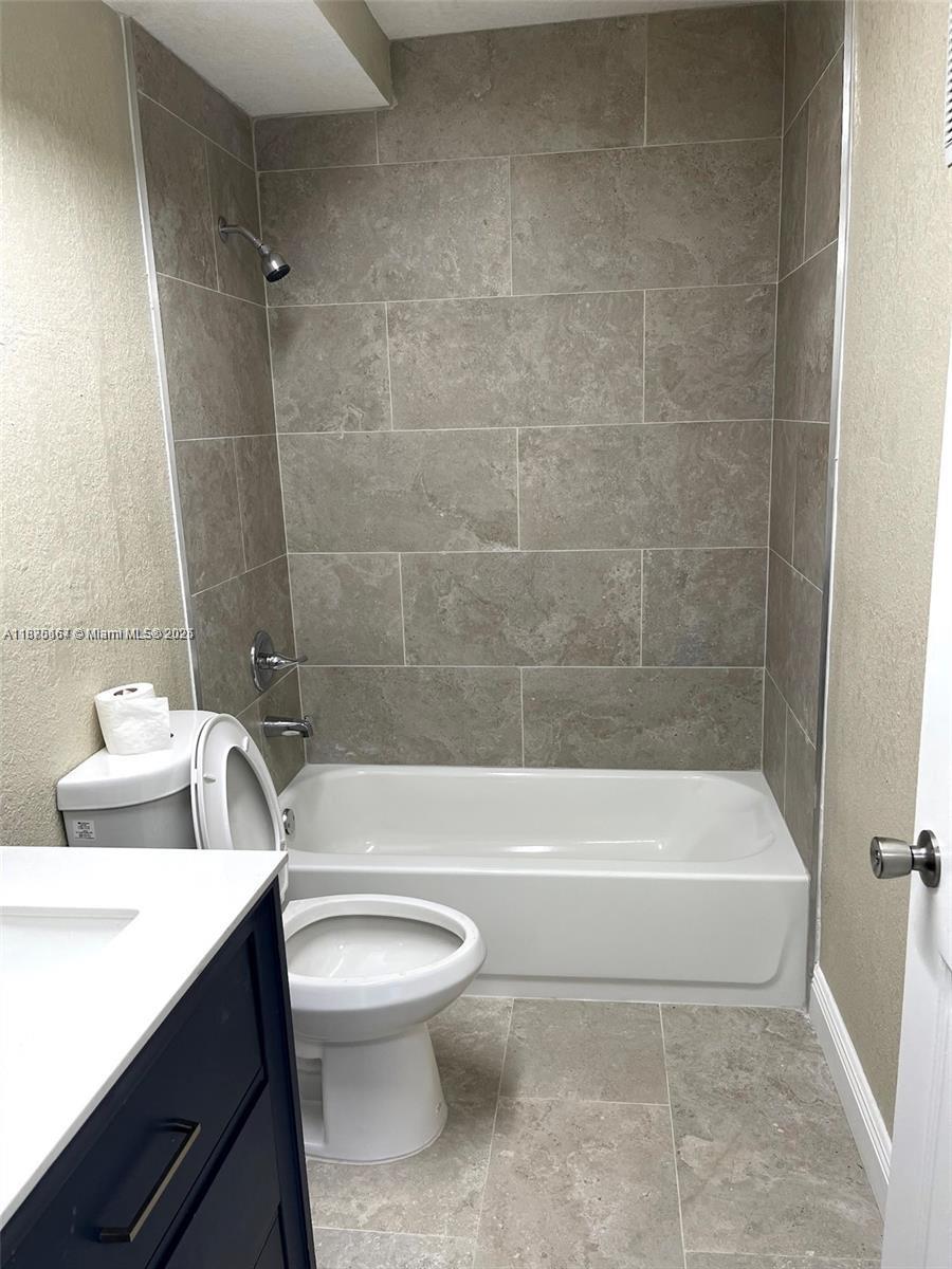 400 Northwest 65th Avenue, Unit 120 Margate, FL 33063 - Photo 11 of 17 a bathroom with a toilet a sink and bathtub