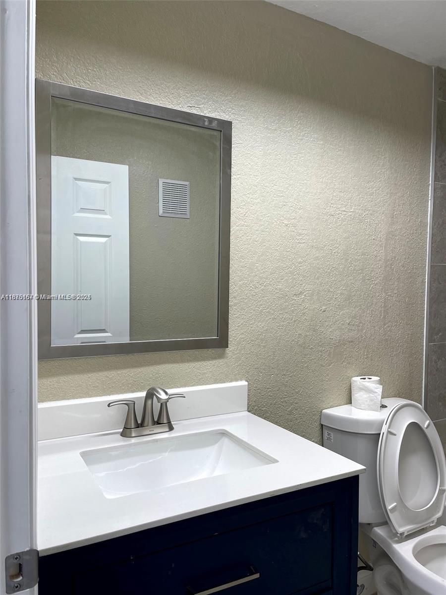 400 Northwest 65th Avenue, Unit 120 Margate, FL 33063 - Photo 12 of 17 a bathroom with a sink vanity and a toilet