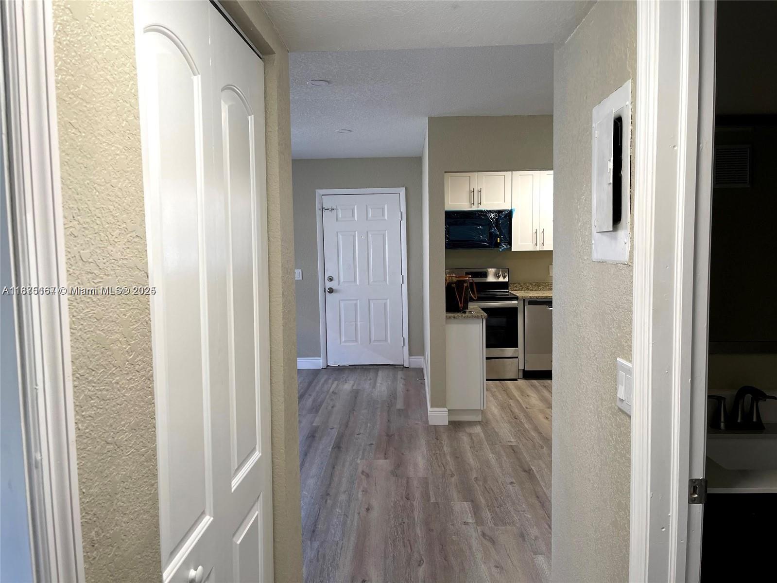400 Northwest 65th Avenue, Unit 120 Margate, FL 33063 - Photo 15 of 17 a view of a hallway with wooden floor and staircase