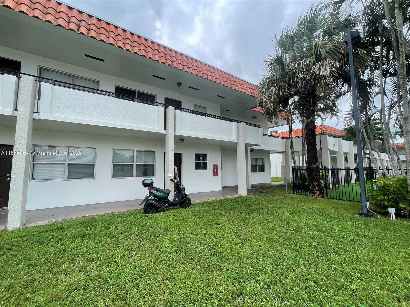 400 Northwest 65th Avenue, Unit 120 Margate, FL 33063 - Photo 3 of 17 a front view of a house with a garden