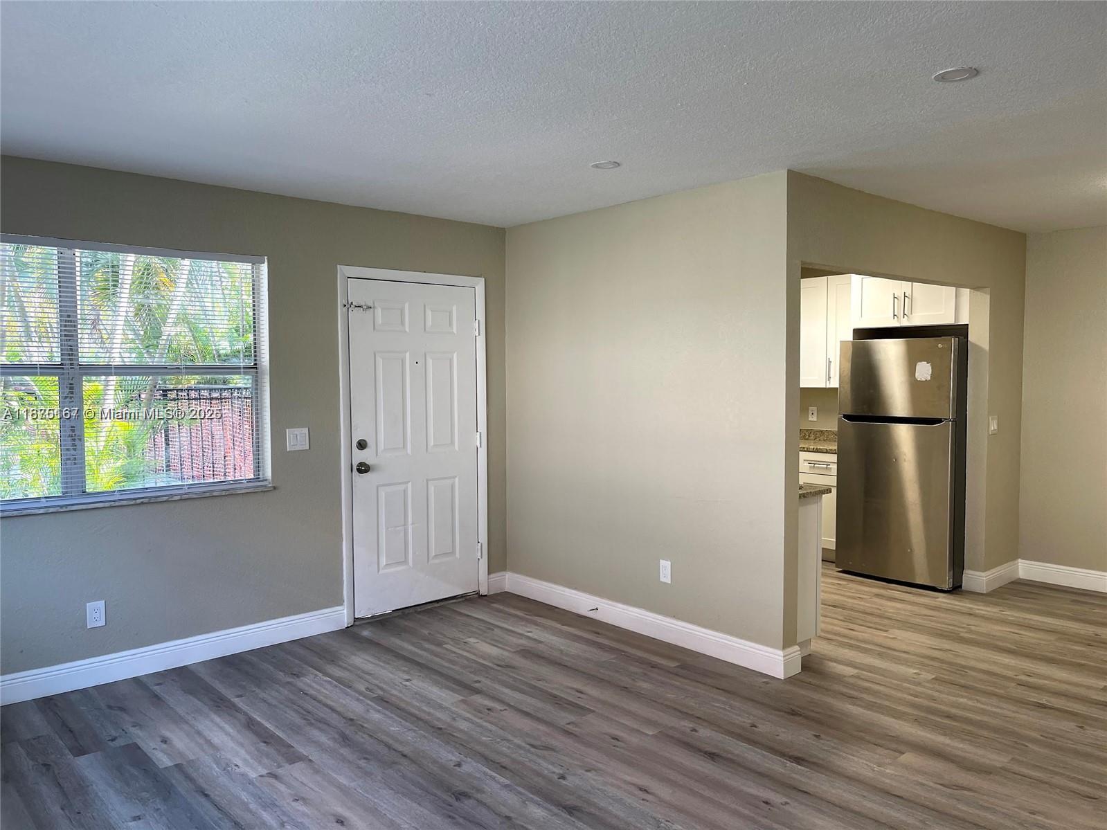 400 Northwest 65th Avenue, Unit 120 Margate, FL 33063 - Photo 4 of 17 a view of empty room with wooden floor and window