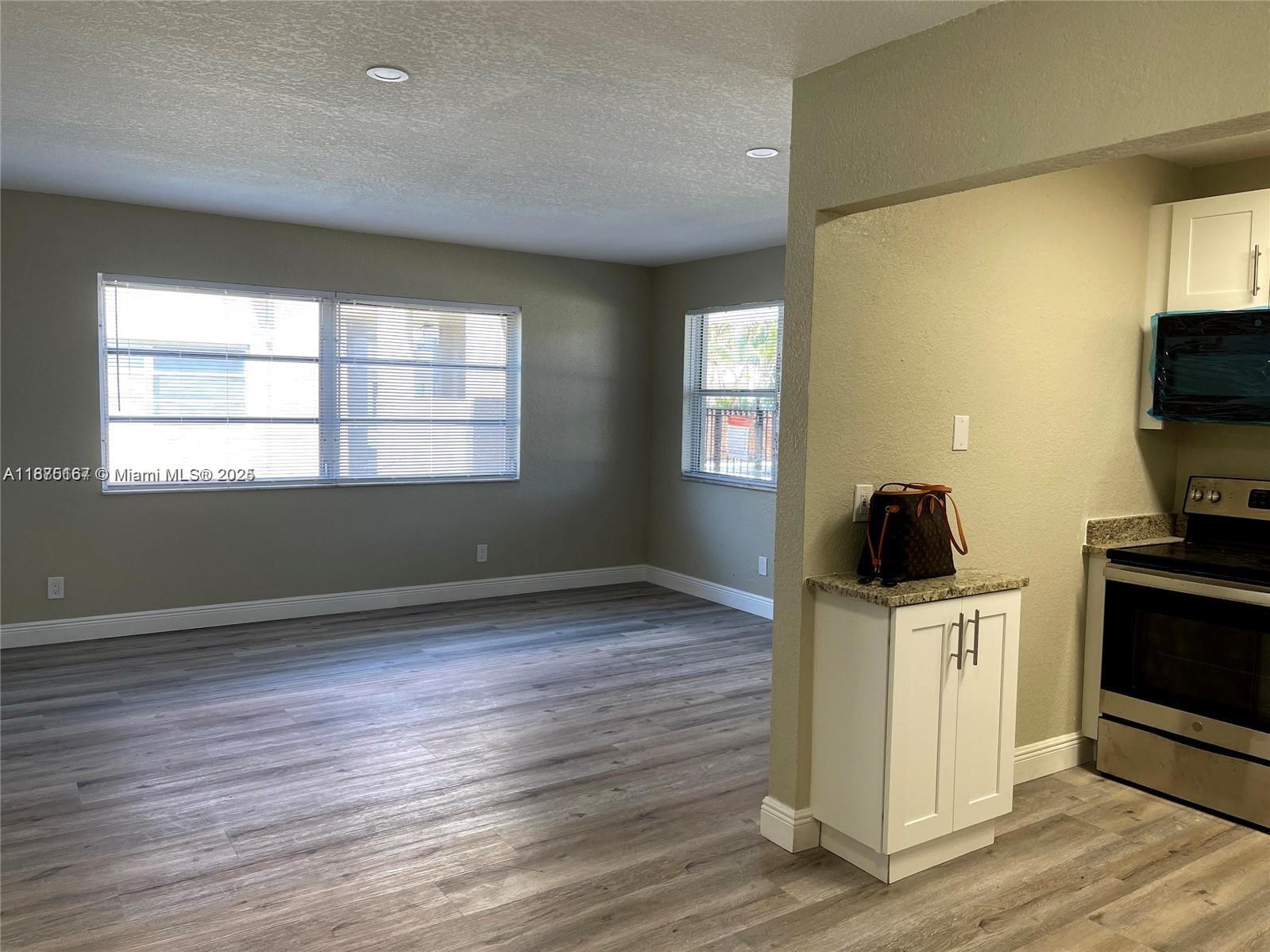 400 Northwest 65th Avenue, Unit 120 Margate, FL 33063 - Photo 5 of 17 a view of a kitchen with wooden floor and electronic appliances