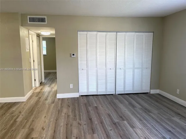 a view of wooden floor and brick walls