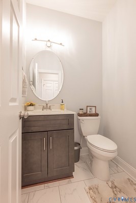 9425 Marie Road New Kent, VA 23124 - Photo 53 of 55 a bathroom with a toilet a sink and mirror