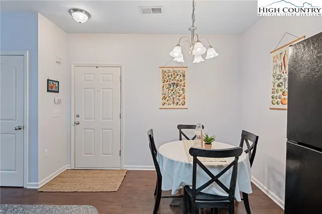 a view of a dining room with furniture wooden floor and a chandelier