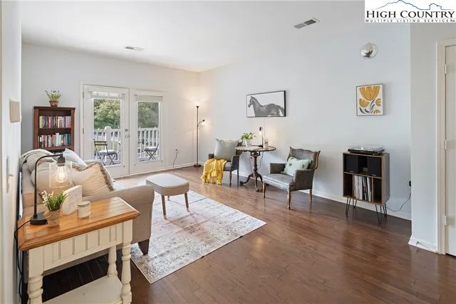 a living room with furniture and wooden floor