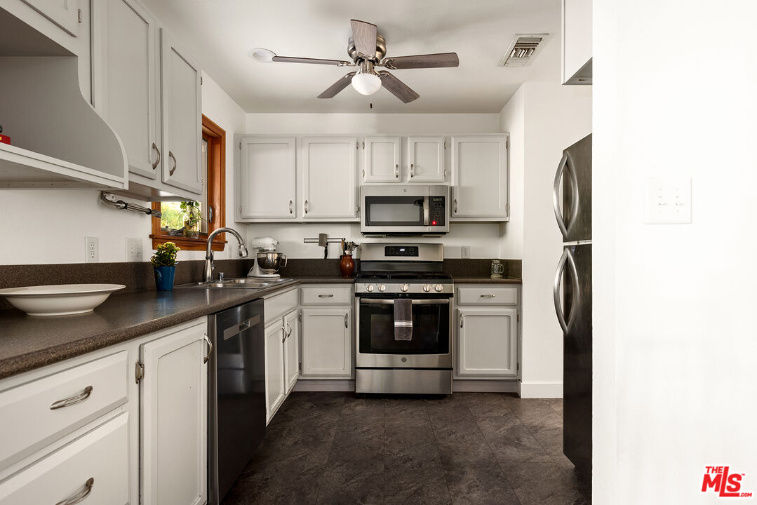 865 Katherine Road Simi Valley, CA 93063 - Photo 6 of 25 a kitchen with stainless steel appliances a stove a sink and a refrigerator