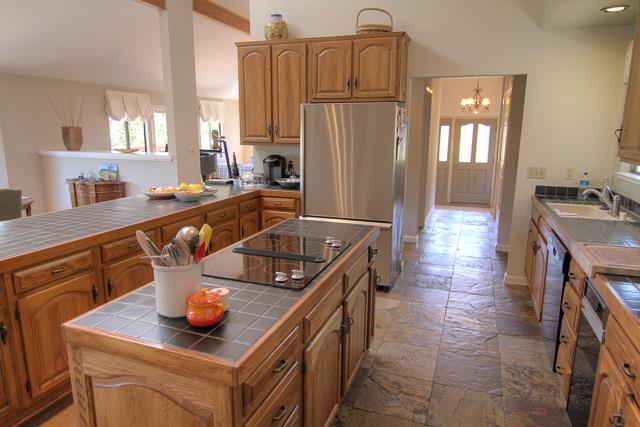 8485 Pharmer Road Gilroy, CA 95020 - Photo 12 of 47 a kitchen with stainless steel appliances granite countertop a sink a stove and refrigerator