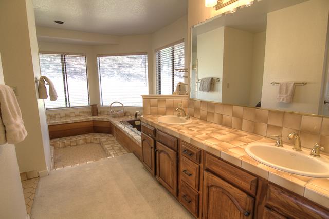8485 Pharmer Road Gilroy, CA 95020 - Photo 19 of 47 a spacious bathroom with a granite countertop sink and a large mirror