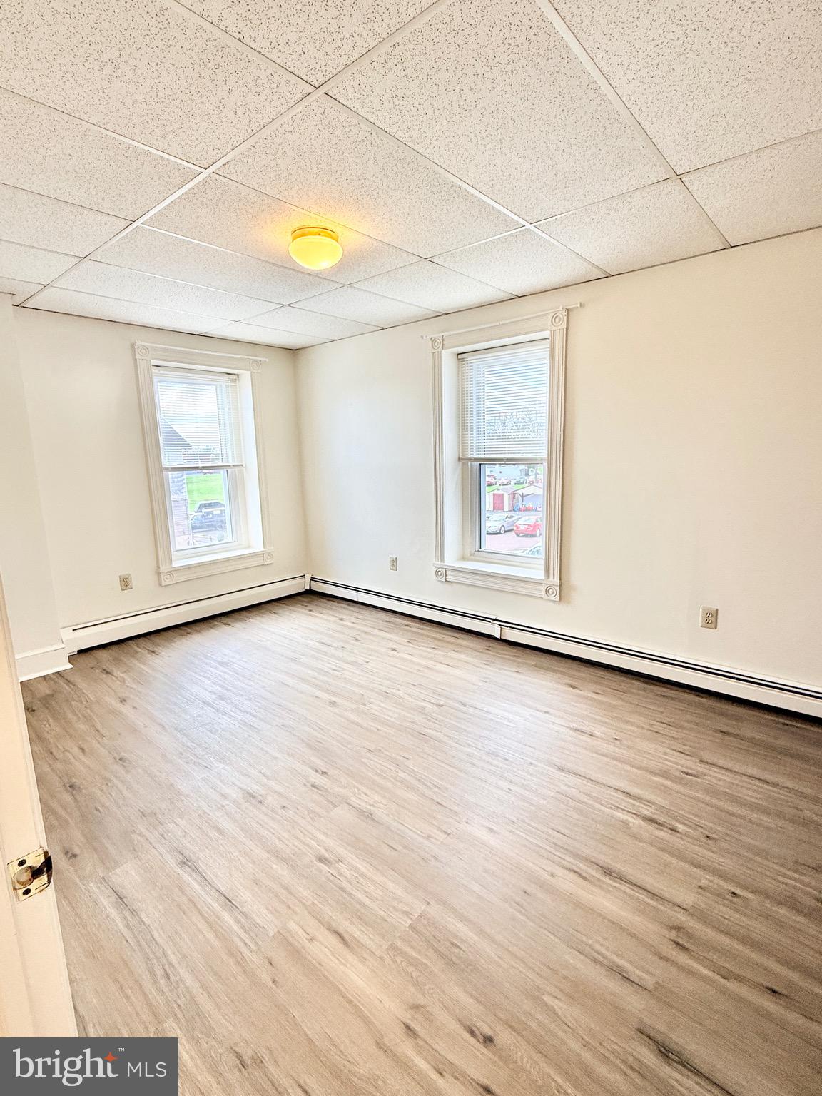 377 West Ridge Pike Royersford, PA 19468 - Photo 12 of 13 an empty room with wooden floor and windows
