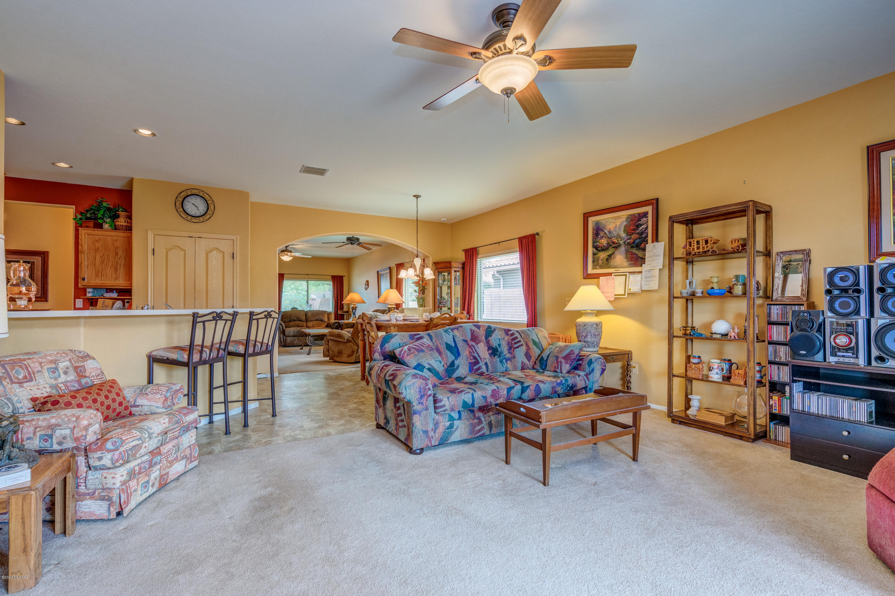 3640 East Northern Dancer Road Tucson, AZ 85739 - Photo 14 of 47 a living room with furniture and a baby crib with the kitchen view