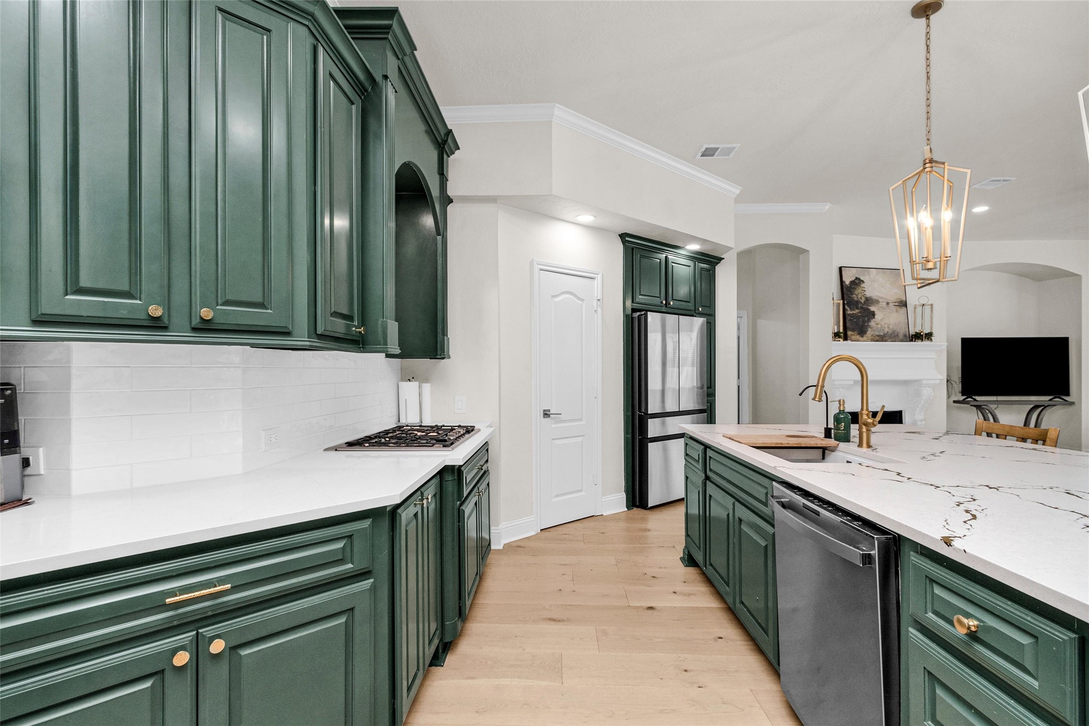10004 Summer Ridge Lane Conroe, TX 77302 - Photo 17 of 50 a kitchen with a sink and a refrigerator