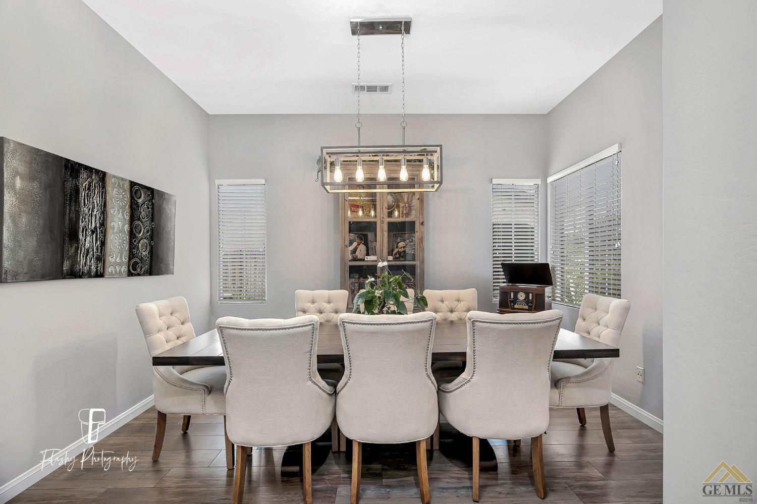 Undisclosed Address Bakersfield, CA 93311 - Photo 11 of 55 a view of a dining room with furniture window and wooden floor