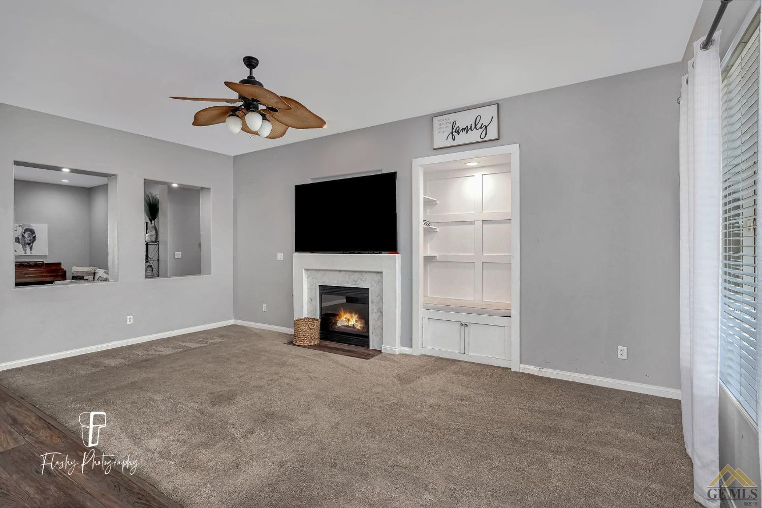 Undisclosed Address Bakersfield, CA 93311 - Photo 18 of 55 a view of an empty room with a fireplace and a window