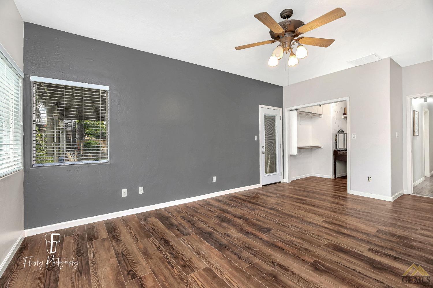 Undisclosed Address Bakersfield, CA 93311 - Photo 26 of 55 a view of an empty room with a chandelier fan and a window