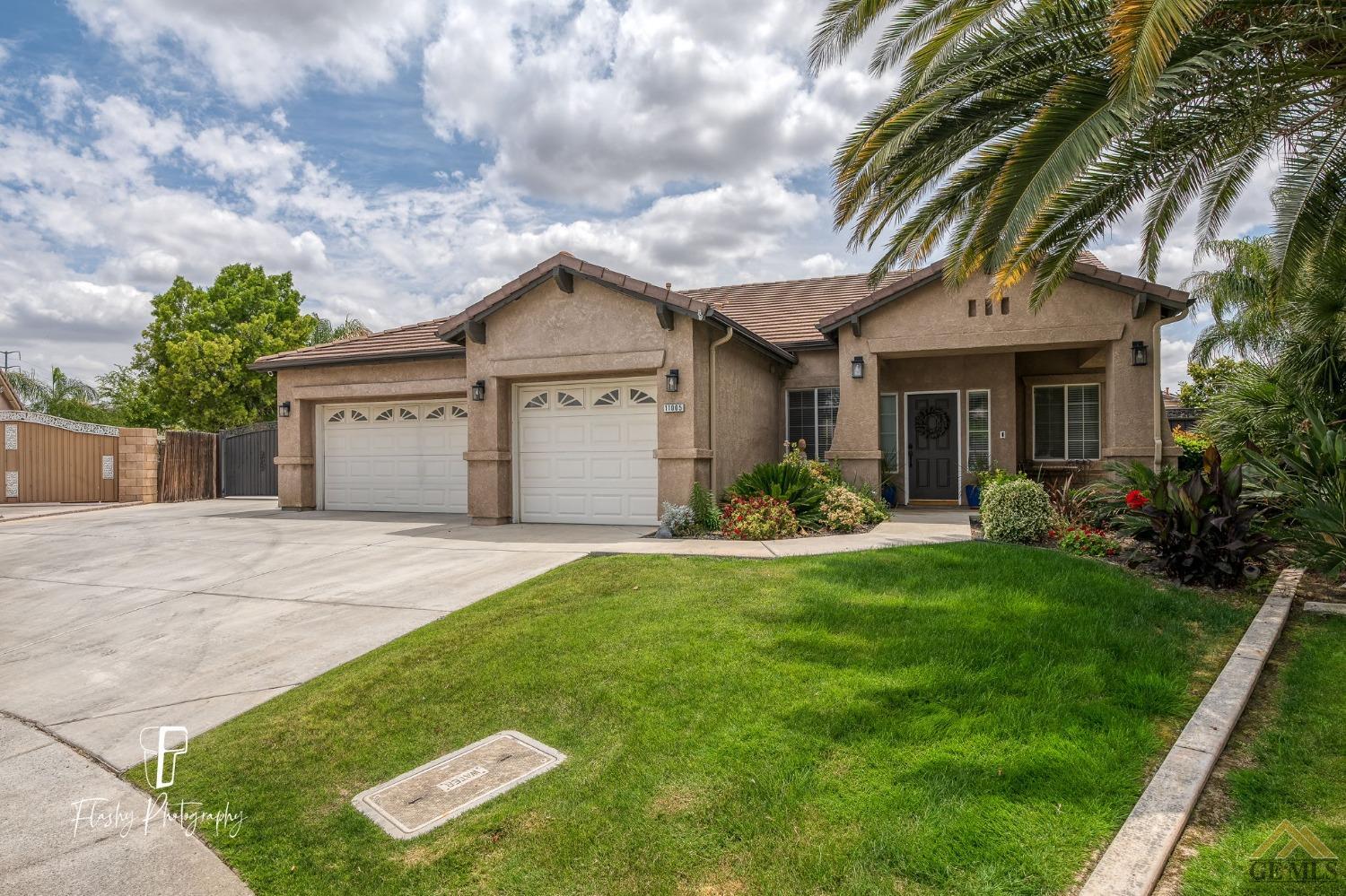 Undisclosed Address Bakersfield, CA 93311 - Photo 3 of 55 a front view of a house with a yard and garage