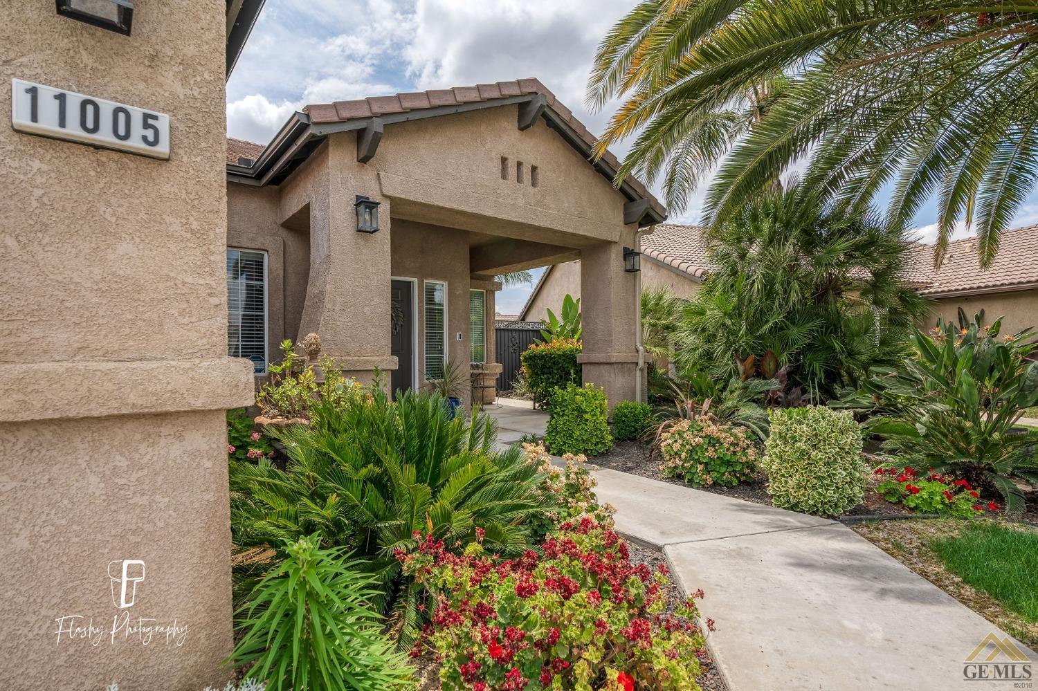 Undisclosed Address Bakersfield, CA 93311 - Photo 4 of 55 a front view of a house with garden