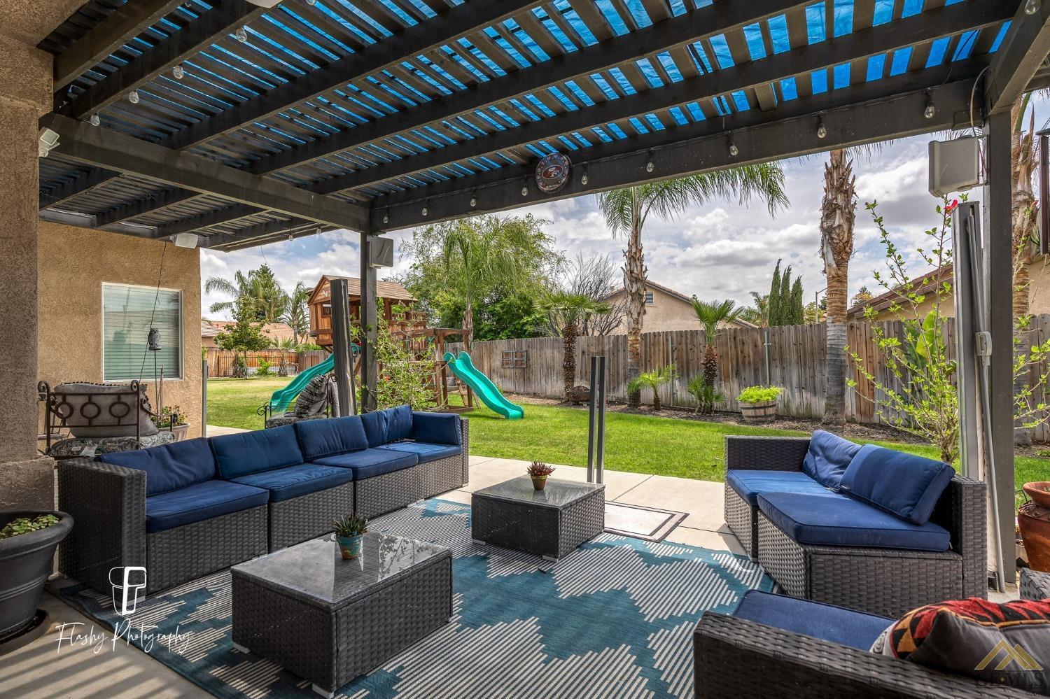 Undisclosed Address Bakersfield, CA 93311 - Photo 42 of 55 a backyard of a house with outdoor seating