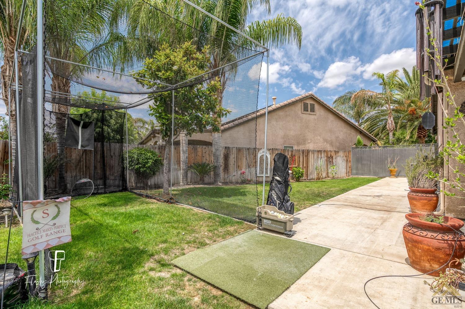Undisclosed Address Bakersfield, CA 93311 - Photo 44 of 55 a view of a house with backyard and a tree