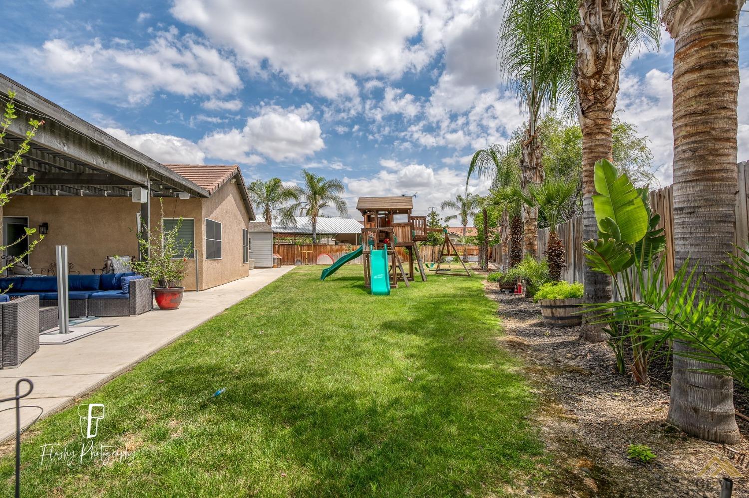 Undisclosed Address Bakersfield, CA 93311 - Photo 46 of 55 a view of a yard with plants and a fountain