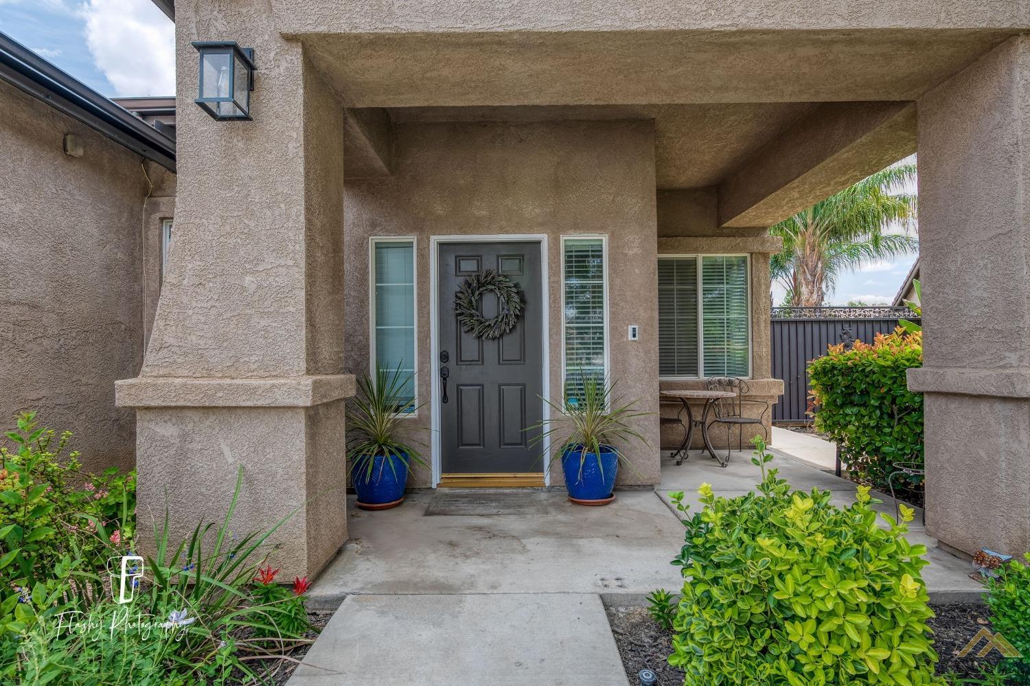Undisclosed Address Bakersfield, CA 93311 - Photo 5 of 55 a view of a patio with table and chairs potted plants