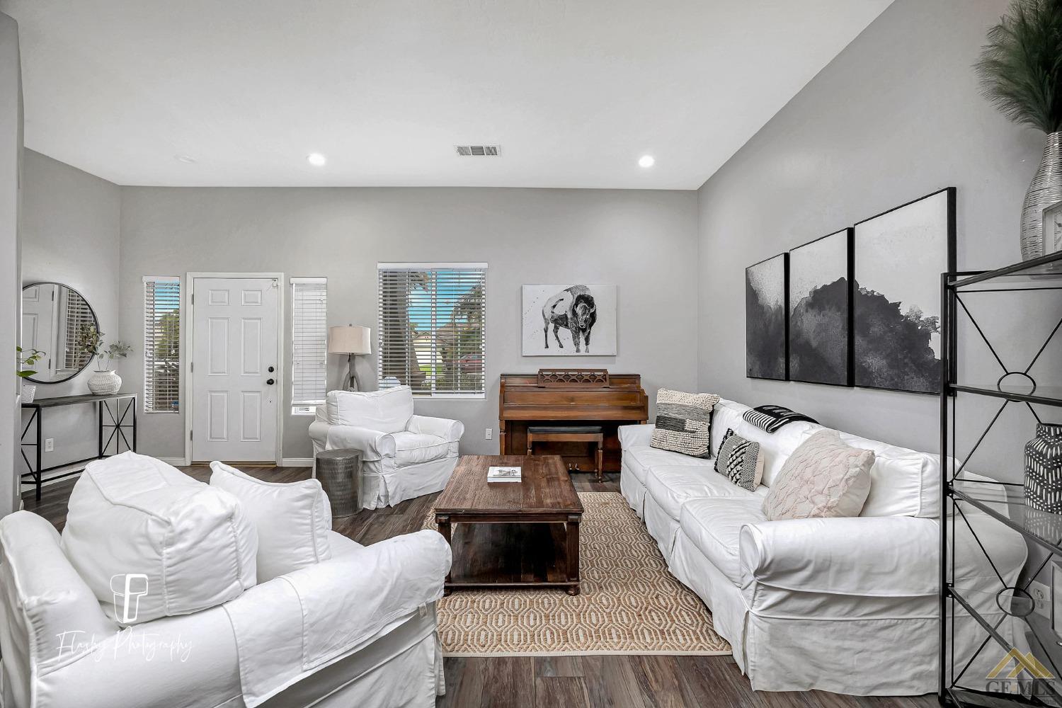 Undisclosed Address Bakersfield, CA 93311 - Photo 8 of 55 a living room with furniture and a wooden floor