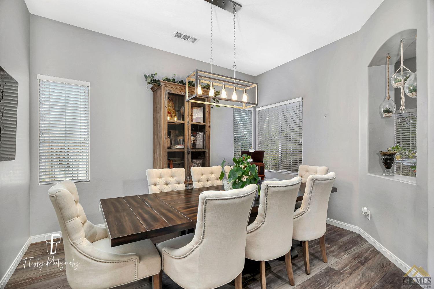Undisclosed Address Bakersfield, CA 93311 - Photo 10 of 55 a dining room with furniture a chandelier and wooden floor