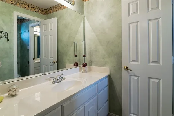 a bathroom with a double vanity sink and a mirror