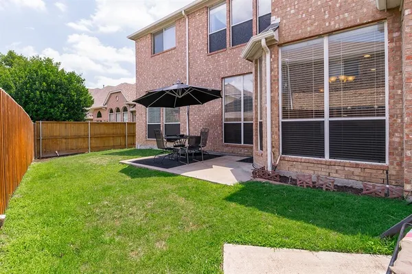 a view of a backyard with a sitting area and slide