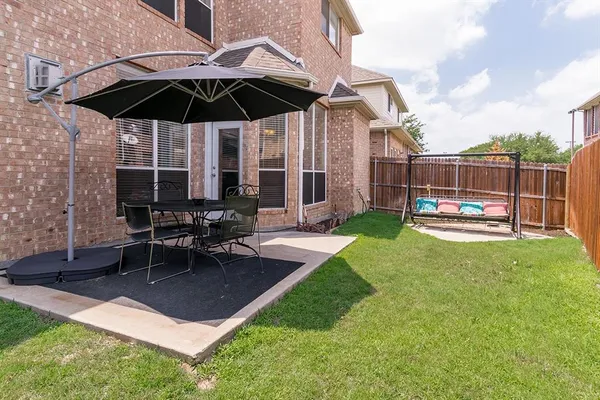 a view of a backyard with a patio and a fire pit