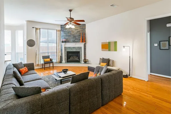 a living room with furniture and a fireplace