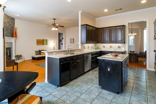 a kitchen with a stove sink and cabinets