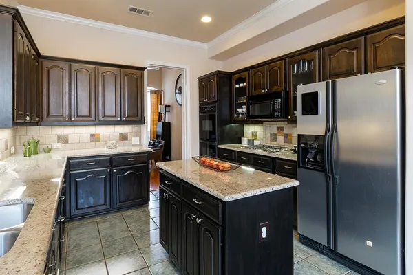 a kitchen with a refrigerator stove top oven and cabinets