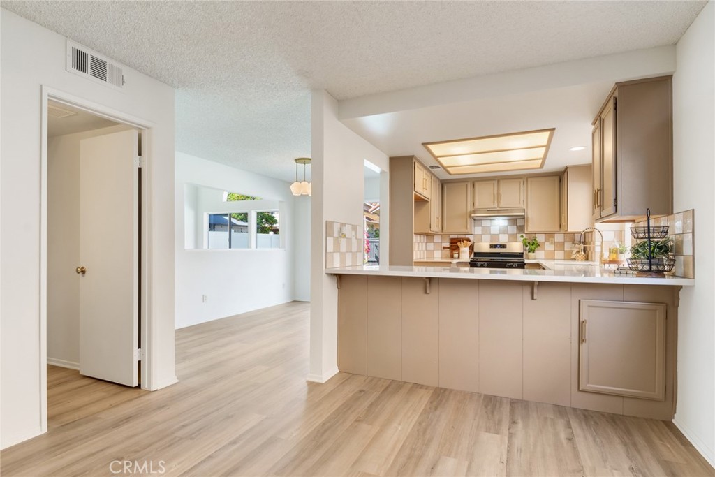 3682 North Pole Lane Riverside, CA 92503 - Photo 11 of 30 a open hall with wooden floor and a sink