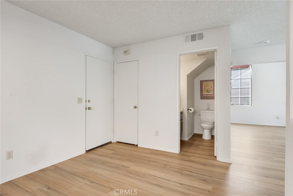 3682 North Pole Lane Riverside, CA 92503 - Photo 16 of 30 a view of empty room with wooden floor and cabinet
