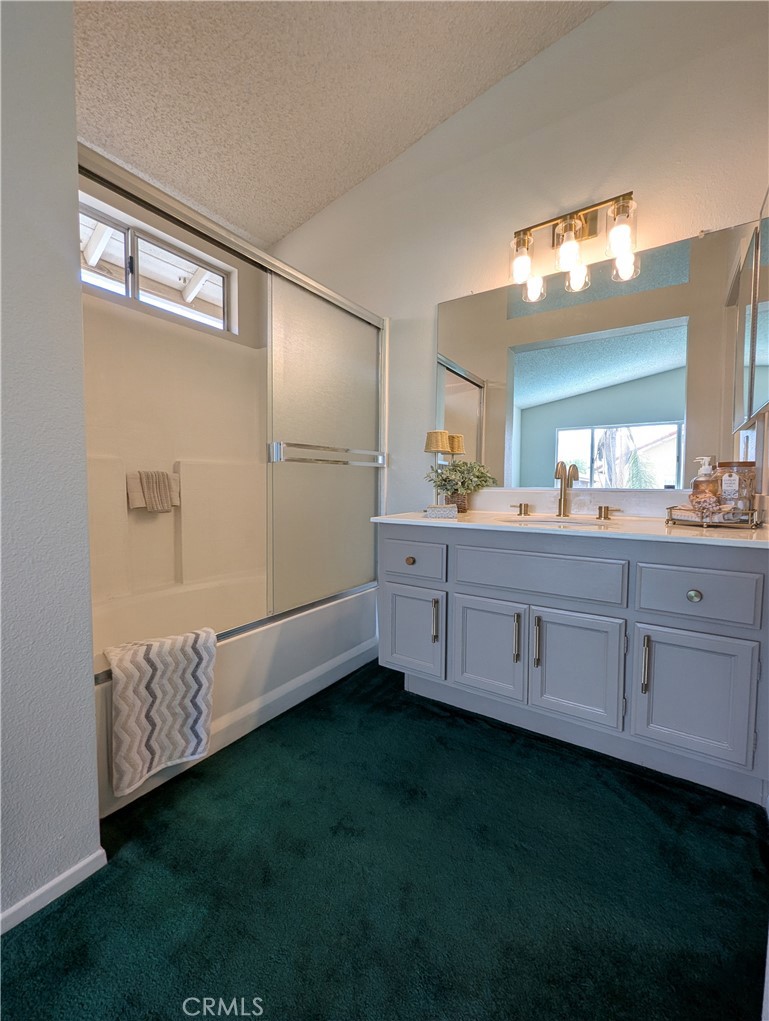 3682 North Pole Lane Riverside, CA 92503 - Photo 20 of 30 a bathroom with a sink a mirror and a bathtub