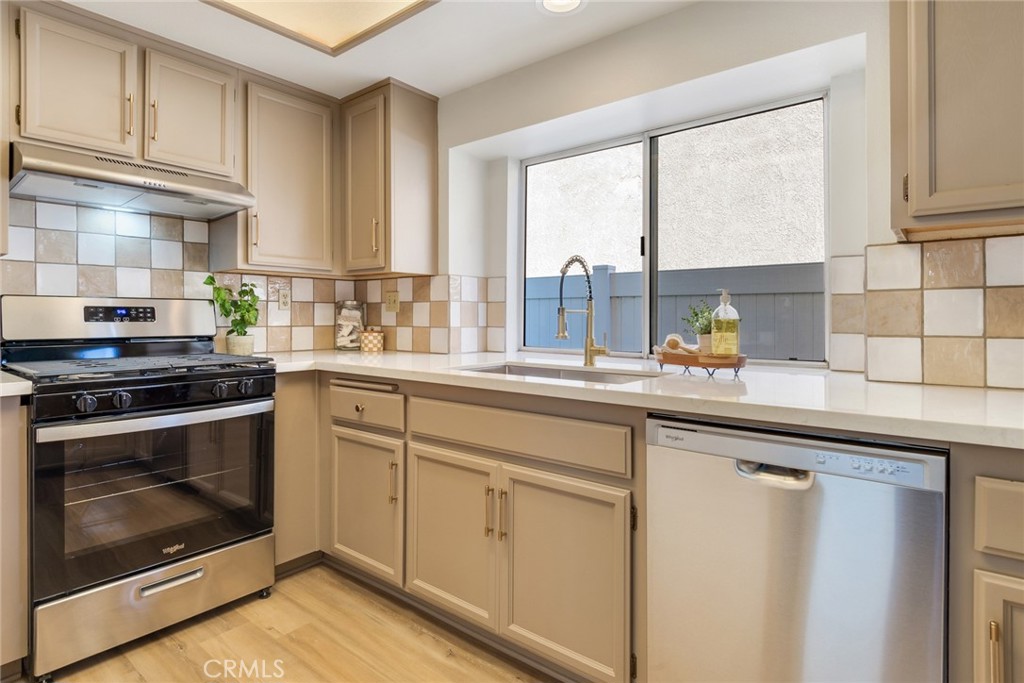3682 North Pole Lane Riverside, CA 92503 - Photo 4 of 30 a kitchen with white cabinets and appliances