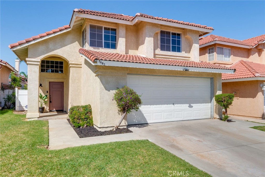 3682 North Pole Lane Riverside, CA 92503 - Photo 5 of 30 a front view of a house with a yard and garage