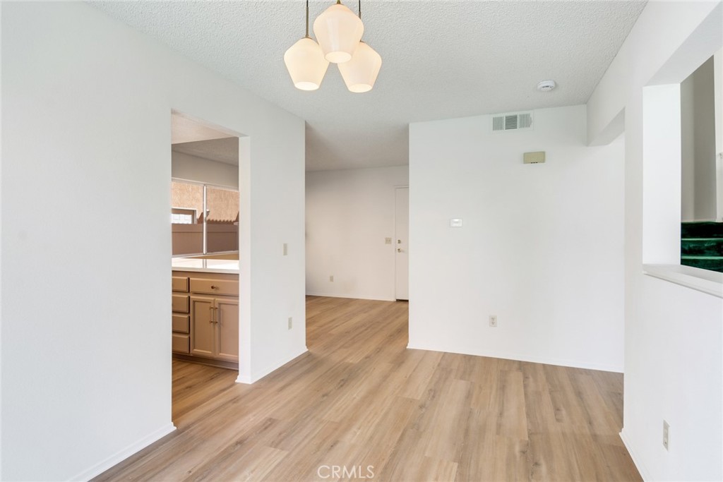 3682 North Pole Lane Riverside, CA 92503 - Photo 10 of 30 an empty room with wooden floor and windows