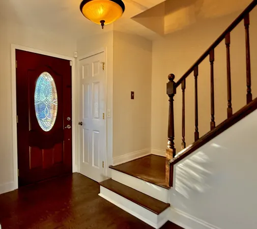 a view of staircase with wooden floor and a window