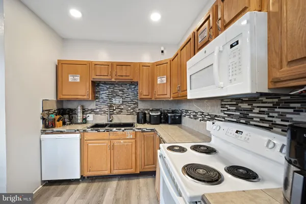 a kitchen with a sink a stove and cabinets