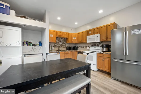 a kitchen with stainless steel appliances granite countertop a sink a stove and a refrigerator