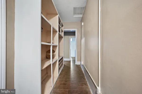 a view of a hallway with wooden floor